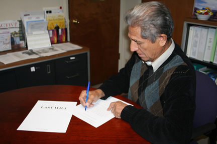 Client signing his will in the Law Office of Derryl H. Molina